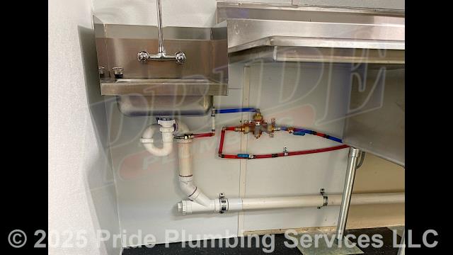 Pride Plumbing came out and performed the following work: 1) cut and removed the PVC drain lines going to a handwashing sink; repiped the new PVC drain lines to meet recently revised plumbing and venting codes - using the sink's existing air admittance valve - and tested the sink and drains for leaks and proper drainage; and 2) cut and removed the P-trap at the wall using a hub-saver tool and reduced the drain piping down to 2-inches for a grease trap discharge line; installed a new 2-inch PVC discharge line coming from the grease trap going to the sewer line - using an existing 3-compartment sink's air admittance valve; and tested the new discharge line for leaks and proper drainage.