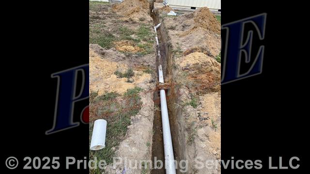 Pride Plumbing came out and performed the following work: 1) dug up an existing 2-inch PVC drain line going to a wet well; 2) installed new 4-inch PVC piping and tracer wire in the ditch along with two two-way cleanouts; 3) core-drilled the side of the catch basin and installed a tap for the new drain line; 4) connected the drain line to the tap and sealed around the tap; and 5) backfilled the ditch after the work was completed and checked for proper drainage and working order.