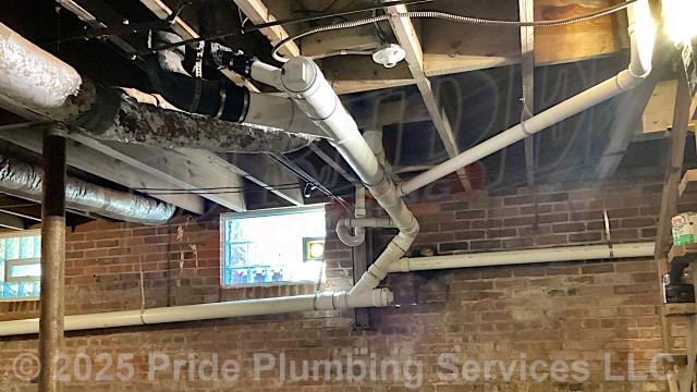 Pride Plumbing came out and repiped and replaced the cast iron drain lines under the house in the basement, going to a) the fixtures in the kitchen (sink and dishwasher) and one bathroom (sink, toilet, and bathtub/shower) - replacing the toilet bowl's flange and wax seal, the P-traps underneath all the sinks, and the bathtub/shower's waste and overflow; and b) the washing machine - installing new PVC piping, fittings and supports under the house and up through the flooring for each fixture and air admittance valves inside the home where needed.