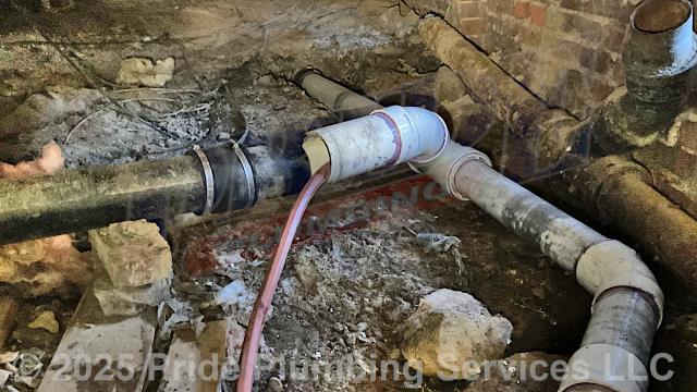 Pride Plumbing was called out for sewage backing up into the home. We separated the drain line underneath the home, used a water pressure device down through the pipe and cleared a blockage in the main outside sewer septic drain line. After reconnecting the drain line, we tested multiple fixtures for proper drainage with no issues. We also provided a cost estimate to 1) trench a ditch from the house to the town sewer tap to expose and remove the terra cotta outside main sewer septic drain line; 2) install a new 4-inch PVC sewer drain line (connecting it to the main drain line under the home) along with proper cleanouts and fittings per code; 3) install tracer wire in the ditch along with the new sewer drain line; and 4) backfill, tamp, and spread grass seed and straw after the work has been inspected and approved by Stanly County's Inspection Department.