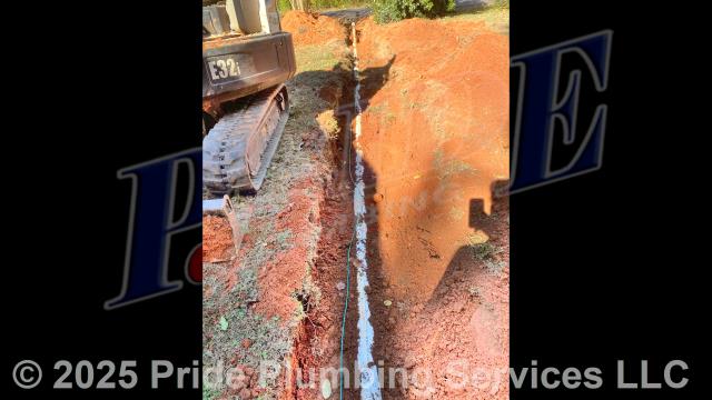 Pride Plumbing came out and 1) used an excavator to trench a ditch from the house to the town sewer tap to expose and remove the outside main sewer septic drain line; 2) installed a new 4-inch PVC sewer drain line (connecting it to the main drain line under the home) along with proper cleanouts and fittings per code; 3) installed tracer wire in the ditch along with the new sewer drain line; and 4) backfilled, tamped, and spread grass seed and straw after the work was inspected and approved by Montgomery County's Inspection Department.