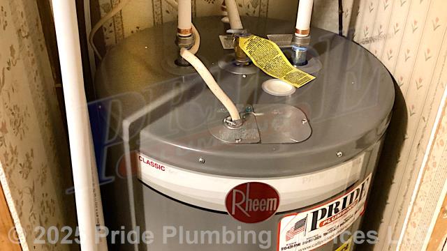 Pride Plumbing came out and replaced a leaking 30-gallon electric water heater with a new 40-gallon electric Rheem PROE40-M2-RH95 model. First, after disconnecting its electrical connections and inlet and outlet water lines, we removed and disposed of the old water heater. Then we installed water heater pads, the new water heater, ball water shut-off valves, PEX and stainless-steel water supply lines to the water heater connectors, a brass drain valve, and wired up the electrical connections to the new water heater (adding a Romex connector). Finally, we bled the air out of the water lines, ensured that the unit’s temperature and pressure (T&P) relief valve was properly vented, and set the unit to its appropriate operating temperature. We also upgraded the unit's elements to 3,500-watt elements due to it being on a double pole 20-amp breaker.
