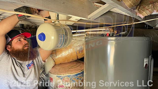 Pride Plumbing came out and replaced a leaking 38-gallon electric U.S. Craftmaster E2F40LD045V lowboy water heater with a new 38-gallon electric Rheem PROE38-S2-RH95-B lowboy model. First, after disconnecting its electrical connections and inlet and outlet water lines, we removed and disposed of the old water heater. Then we installed the new water heater, a HydroPro H10000 HPTET2 thermal expansion tank, ball water shut-off valves, PEX and stainless-steel water supply lines to the water heater connectors, a brass drain valve, and wired up the electrical connections to the new water heater (adding a Romex connector). Finally, we bled the air out of the water lines, ensured that the unit’s temperature and pressure (T&P) relief valve was properly vented, and set the unit to its appropriate operating temperature.