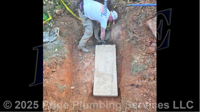 Pride Plumbing came out and performed the following work: 1) used a backhoe to uncover a septic tank and remove its concrete lid; 2) called in our septic pumping truck and pumped out the septic tank; 3) ensured proper drainage into the tank from multiple fixtures inside the home; 4) used the backhoe to replace the concrete lid and set it in place over the septic tank; and 5) covered the septic tank back up with dirt. We used hydraulic cement to repair a broken section of the septic tank rim so the new lid would fit properly and seal correctly.