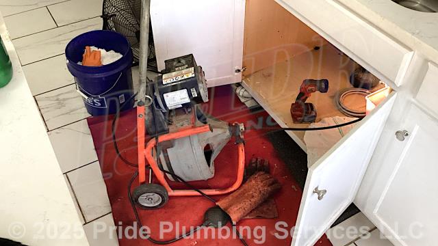 Pride Plumbing was called out for a water leak underneath a kitchen sink. Our inspection found that one of the sink's basket strainers was leaking. We removed and replaced the basket strainer and flange tailpiece, tested for leaks, and the issue was corrected. The kitchen sink's drain line was also clogged, so we used a sewer machine and cleared the blockage.
