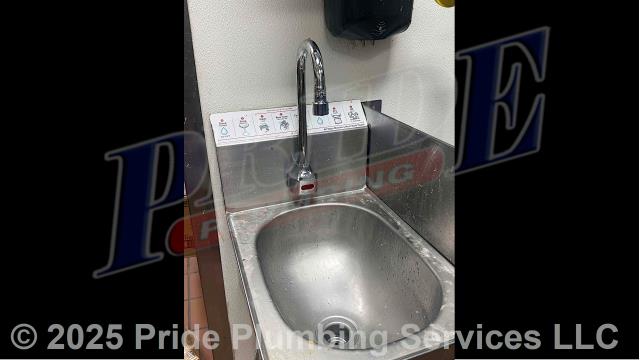 Pride Plumbing came out and removed and replaced a non-working electronic touchless handwash sink faucet with a new T&S Brass EC-3132 electronic touchless model. This included removing the old faucet, mounting the new faucet, replacing the hot and cold above-floor braided stainless steel water supply lines underneath the sink, and connecting the faucet's electronic control module.