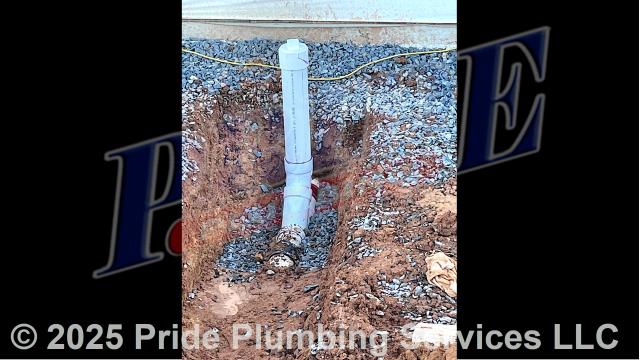 Pride Plumbing came out, dug down to and uncovered the outside main sewer septic drain line, cut into it, and installed a new two-way PVC cleanout with a cap (connecting it to the existing outside main sewer septic drain line with new PVC fittings and two Fernco couplings). We also busted the concrete around a floor drain, dug down and raised it to the appropriate building code level, and backfilled the area we dug out with dirt.