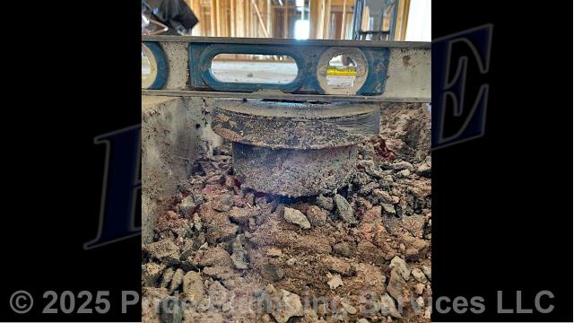 Pride Plumbing came out, dug down to and uncovered the outside main sewer septic drain line, cut into it, and installed a new two-way PVC cleanout with a cap (connecting it to the existing outside main sewer septic drain line with new PVC fittings and two Fernco couplings). We also busted the concrete around a floor drain, dug down and raised it to the appropriate building code level, and backfilled the area we dug out with dirt.