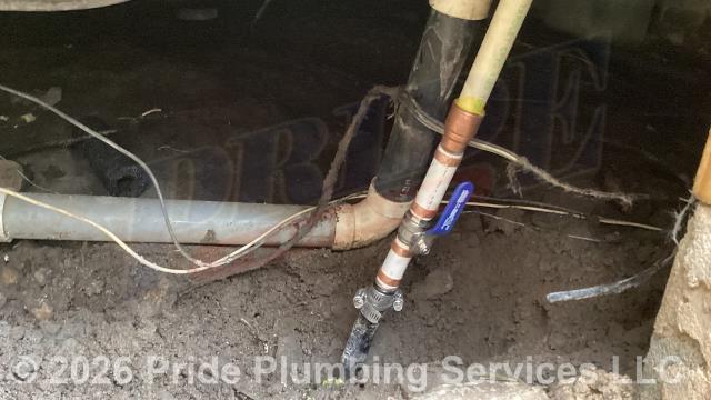 Pride Plumbing was called out for a water leak underneath the home. We found a leak on the main black roll water supply line coming into the foundation. After shutting off the water, we cut out the leaking section of pipe and repaired it with new PEX piping and fittings and added a new ball shutoff valve. We then cut the water back on, drained out any debris at an outside hose bib spigot, and tested for leaks with no further issues. We also provided a cost estimate to repipe and replace the water supply lines under the house in the crawlspace, going to the fixtures in the kitchen (sink faucet, dishwasher, and ice maker), one bathroom (sink, toilet, and bathtub/shower), the washing machine (installing a new plastic washer box and hot and cold hose bibs or boiler drains), and the water heater, with new PEX piping and fittings (installing new 1/4 turn water shut-off valves on each fixture inside the house along with new above-floor stainless steel braided water supply lines).