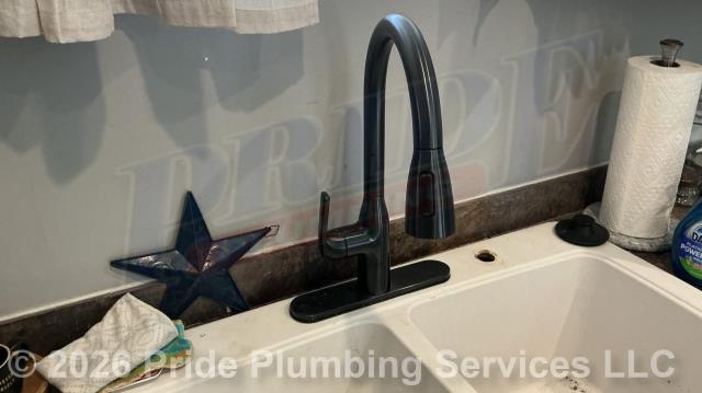 Pride Plumbing came out and replaced a centerset kitchen sink faucet with a new customer-supplied centerset model with a pulldown sprayer. This included removing the old faucet, mounting the new faucet, and replacing the hot and cold above-floor water supply lines underneath the sink with new braided stainless-steel ones and connecting them to the water supply stops and faucet.