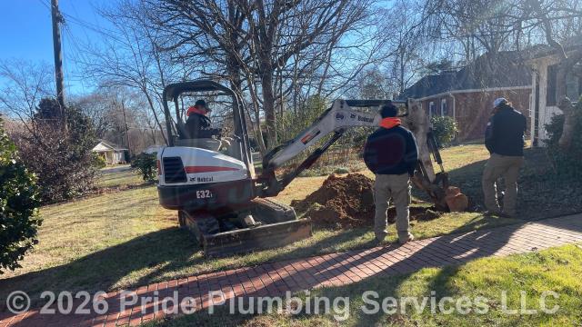 Pride Plumbing came out and 1) used an excavator to trench a ditch from the house to the town sewer tap to expose and remove the outside main sewer septic drain line; 2) installed a new 4-inch PVC sewer drain line (connecting it to the town's sewer tap at the edge of the property and the main drain line underneath the home) along with proper cleanouts and fittings per code; 3) installed tracer wire in the ditch along with the new sewer drain line; and 4) backfilled, tamped, and spread grass seed and straw after the work was inspected and approved by Randolph County's Inspection Department.