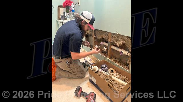 Pride Plumbing came out and pulled a two-sink bathroom vanity away from the wall (disconnecting its water and drain lines), cut an access in the wall, and replaced the drain piping behind the wall with new PVC piping and fittings.