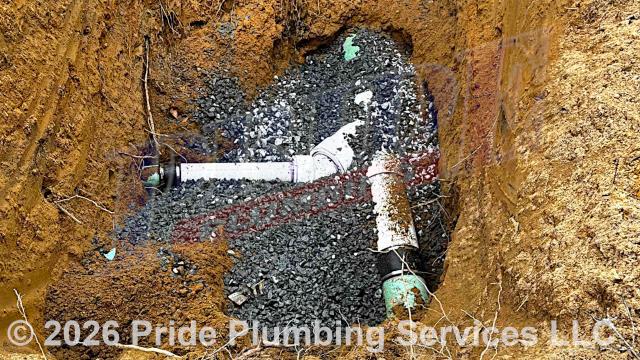 Pride Plumbing was called out for a water leak in the yard close to the highway. We dug down and found a leak on a section of the outside main drain line - the building's main drain line had not been connected to the city's main drain line. We cut out the faulty sections of pipe, repaired them with new PVC piping and fittings (adding a PVC wye, street bend, and bushing) - connecting onto the existing drain lines with two new Fernco couplings, poured gravel underneath the pipe to maintain the correct fall, and ran several fixtures inside the building to check for leaks and proper drainage.