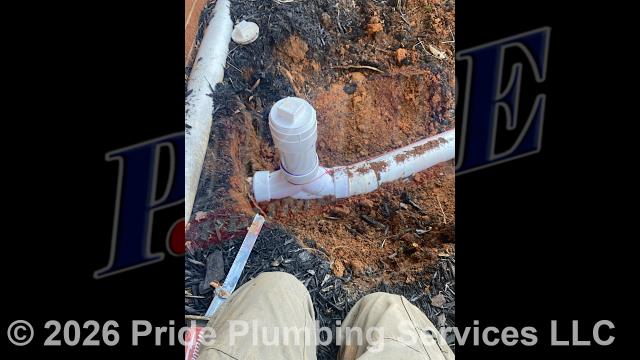 Pride Plumbing came out and 1) used an excavator to trench a ditch from the house to the town sewer tap to expose and remove the outside main sewer septic drain line; 2) installed a new 4-inch PVC sewer drain line (connecting it to the town's sewer tap at the edge of the property and the main drain line underneath the home) along with proper cleanouts and fittings per code; 3) installed tracer wire in the ditch along with the new sewer drain line; and 4) backfilled, tamped, and spread grass seed and straw after the work was inspected and approved by Stanly County's Inspection Department.