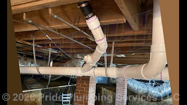 Pride Plumbing came out and repiped and replaced the drain lines under the house in the crawlspace, going to a) the fixtures in the kitchen (sink and dishwasher) and two bathrooms (sinks, toilets, and bathtubs/showers - replacing the toilet bowl flanges and wax ring gaskets, the bathtub/shower drains, and the P-traps underneath all the sinks, and the bathtub/shower's waste and overflow); and b) the washing machine - installing new PVC piping, fittings and supports under the house and up through the flooring for each fixture and air admittance valves inside the home where needed. We also dug down to the outside main sewer septic drain line outside at the foundation, cut into it, installed a new two-way PVC cleanout, and covered the hole we dug out.