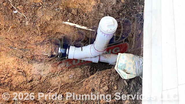 Pride Plumbing came out and repiped and replaced the drain lines under the house in the crawlspace, going to a) the fixtures in the kitchen (sink and dishwasher) and two bathrooms (sinks, toilets, and bathtubs/showers - replacing the toilet bowl flanges and wax ring gaskets, the bathtub/shower drains, and the P-traps underneath all the sinks, and the bathtub/shower's waste and overflow); and b) the washing machine - installing new PVC piping, fittings and supports under the house and up through the flooring for each fixture and air admittance valves inside the home where needed. We also dug down to the outside main sewer septic drain line outside at the foundation, cut into it, installed a new two-way PVC cleanout, and covered the hole we dug out.