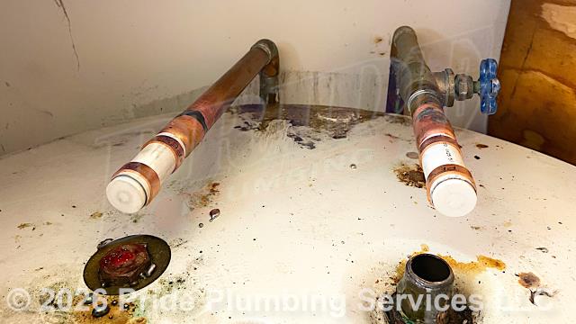 Pride Plumbing was called out for a water leak on an A.O. Smith lowboy water heater. Our inspection found that the water heater was leaking from its anode rod. The customer wanted us to cap off the unit's poly water inlet and outlet lines. So, after cutting off the water, we cut and used PEX piping and fittings to cap the water lines. We then turned the water back on and tested for leaks with no issues. We also provided cost estimates to 1) repipe and replace the water supply lines under the house in the crawlspace, going to the fixtures in the kitchen and one bathroom, and at the washing machine and water heater, with new PEX piping and fittings; and 2) install a new pressure reducing valve (PRV) at the water meter.