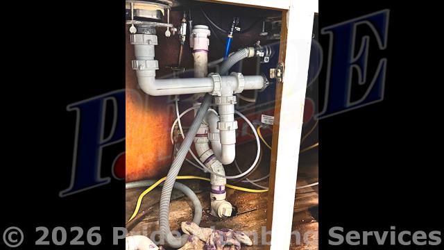 Pride Plumbing came out and replaced a toilet with a new Gerber Viper round-front model. This included draining and pulling the old toilet, inspecting and cleaning the flange, replacing the toilet bowl, toilet tank, tank to bowl gasket and bolts, seat, wax ring gasket, toilet bowl bolts, toilet bowl bolt washers, toilet bowl bolt caps, and above-floor braided stainless-steel water supply line. Once installed, we tested for leaks and proper operation with no issues. We also replaced a kitchen sink's under-sink drain assembly, P-trap, and drain line through the floor to under the house in the crawlspace, and to where it ties into the main sewer drain stack, with new PVC piping and fittings (adding three 1/16-inch bends and a Santee). Also, underneath the sink, we added an air admittance valve on the drain assembly.