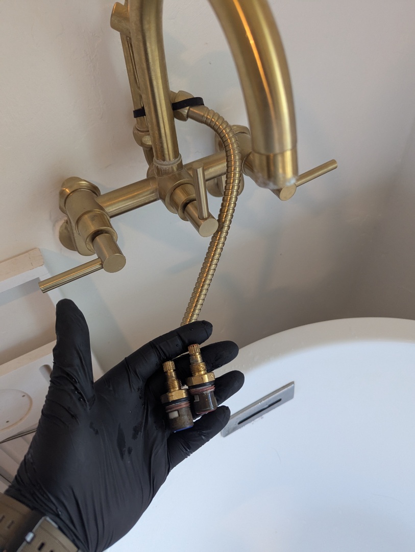 Replacing cartridges on Kingston Brass roman tub faucet.