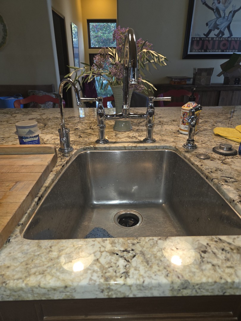 Securely mounted customer installed kitchen faucet and tight Island sink location