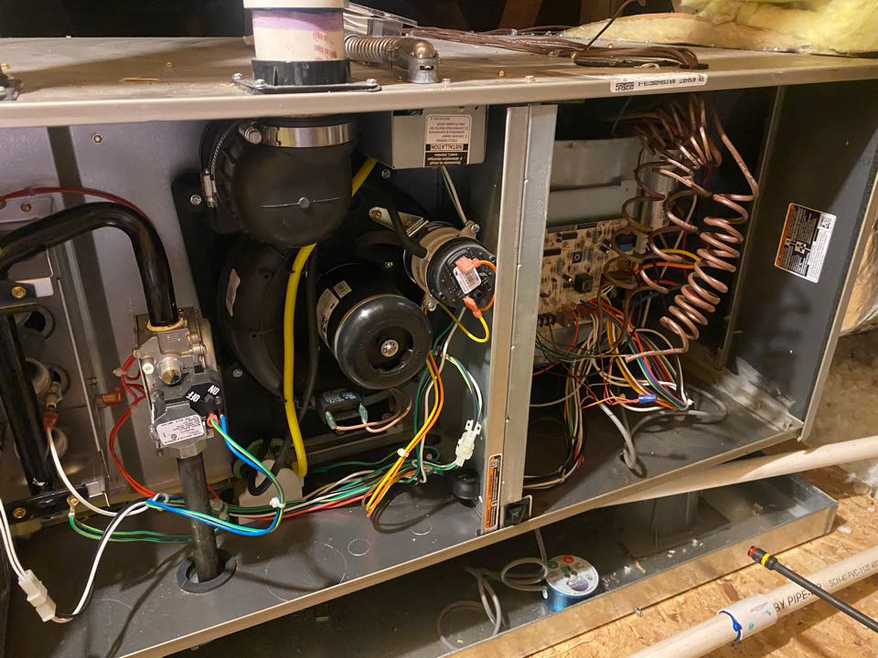 Maintenance on a gas furnace.