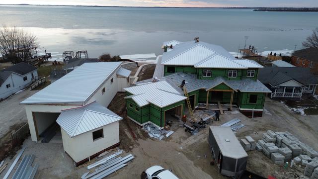 This beautiful home in LaSalle needed a top-notch roofing solution that could withstand the elements while also looking sleek and modern. The real challenge was to find a system that combined durability with precise detailing across various structures, including the main house and a boat shed.

We opted for 14" wide SS550 SnapLock panels made from 24-gauge heavy galvalume steel for the house, and paired it with SS200 mechanical lock panels for the shed. To tie everything together, our team added a complete trim package—ridge caps, valleys, gables, sidewalls, eave drip edges, and chimney flashing—making sure every transition was perfectly sealed and reinforced.

Thanks to hidden fasteners, Snap-Z ridge venting, and the right underlayment along with an ice-and-water shield, this roof not only boosts the home’s curb appeal but also provides long-lasting reliability and protection against the weather.

The end result is a roofing system designed to perform for decades, showcasing why