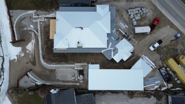 This beautiful home in LaSalle needed a top-notch roofing solution that could withstand the elements while also looking sleek and modern. The real challenge was to find a system that combined durability with precise detailing across various structures, including the main house and a boat shed.

We opted for 14" wide SS550 SnapLock panels made from 24-gauge heavy galvalume steel for the house, and paired it with SS200 mechanical lock panels for the shed. To tie everything together, our team added a complete trim package—ridge caps, valleys, gables, sidewalls, eave drip edges, and chimney flashing—making sure every transition was perfectly sealed and reinforced.

Thanks to hidden fasteners, Snap-Z ridge venting, and the right underlayment along with an ice-and-water shield, this roof not only boosts the home’s curb appeal but also provides long-lasting reliability and protection against the weather.

The end result is a roofing system designed to perform for decades, showcasing why