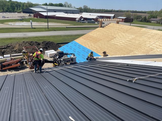 Horst Construction wanted a roof for their new office and showroom that went beyond the look and performance of traditional barn steel. They chose SS550 hidden fastener SnapLock panels to achieve a clean, modern finish that matched the quality of their new building.

The challenge came with the scale of the project: the roof required panels over 30 feet long, which would normally be difficult to transport without risking shipping damage.

Our solution was to bring the roll former directly to the jobsite in Horst Construction’s yard. By roll-forming the 24-gauge SnapLock panels right on the roof deck, we eliminated shipping risks, ensured perfect panel lengths, and allowed for a faster, more efficient installation.

The result is a seamless, high-performance standing seam roof that elevates the company’s new office and showroom while showcasing the precision and durability that Country Towne delivers.