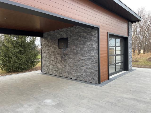 This modern pool shed wasn’t just about function—it needed to impress. The homeowner wanted a bold, maintenance-free exterior that would stand out and make an impression when friends came over. He trusted Country Towne to deliver the right look with premium metal siding, woodgrain accents, and clean architectural lines.

The result? A sleek, durable finish that pairs perfectly with stonework and glass, creating a backyard centerpiece built to last.

When the job needs to be done right, homeowners in Sarnia know they can count on us to deliver materials that combine style, strength, and curb appeal.