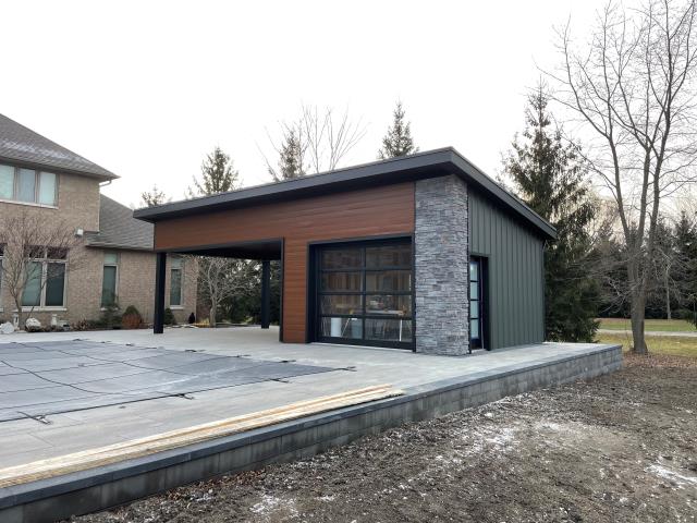 This modern pool shed wasn’t just about function—it needed to impress. The homeowner wanted a bold, maintenance-free exterior that would stand out and make an impression when friends came over. He trusted Country Towne to deliver the right look with premium metal siding, woodgrain accents, and clean architectural lines.

The result? A sleek, durable finish that pairs perfectly with stonework and glass, creating a backyard centerpiece built to last.

When the job needs to be done right, homeowners in Sarnia know they can count on us to deliver materials that combine style, strength, and curb appeal.