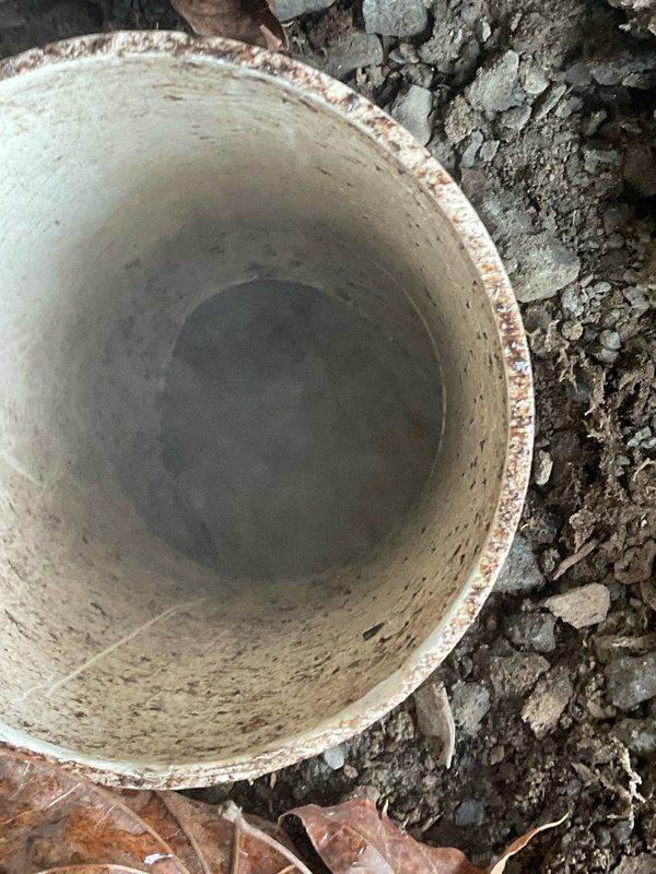Responded to mainline backup affecting all fixtures in single-bathroom residence. Upon arrival, confirmed wastewater backing up into bathtub when toilets flushed and laundry drained. No accessible cleanout located on property. Excavated exterior ground near foundation to establish access point to main sewer line. Successfully cleared blockage using cable machine, restoring proper drainage to all plumbing fixtures. Tested system by running water through multiple fixtures simultaneously to verify clearance and proper flow.