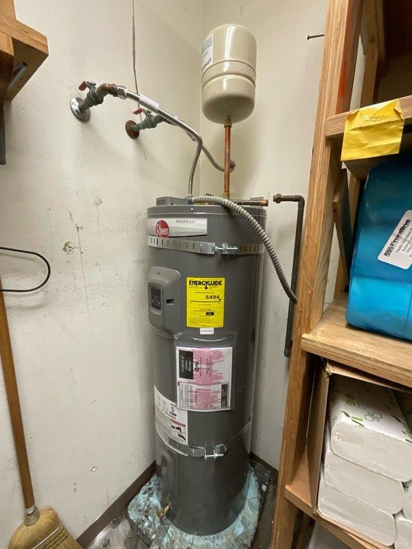 Responded to service call for non-functional electric water heater and leaking toilet. Upon inspection, assessed 50-gallon electric water heater unit with expansion tank and existing plumbing connections, documented current installation configuration including copper piping, shut-off valves, and flexible connector. Evaluated toilet fixture and flush valve assembly to identify source of leak and determine necessary repairs.