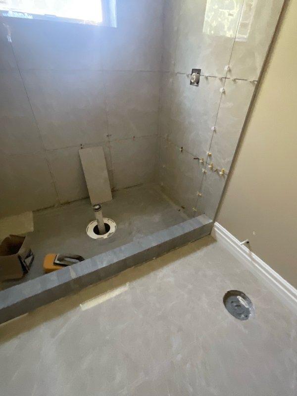 Conducted complimentary estimate for electrical trim-out work on residential bathroom and utility closet where rough-in electrical was previously completed by another contractor. Documented existing conditions including partially tiled bathroom with exposed electrical junction boxes, incomplete wall finishes, and utility closet with floor drain requiring finish electrical installation of fixtures, outlets, switches, and lighting to complete the project that has been in progress for approximately eighteen months.