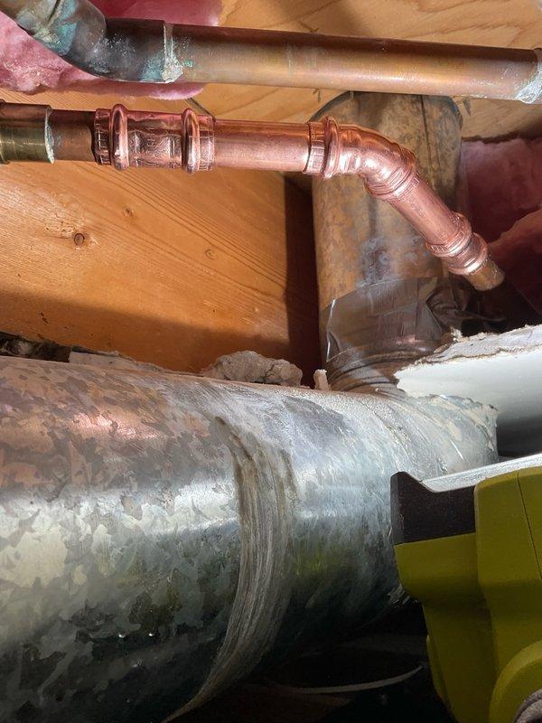 Responded to report of leaking copper pipe in ceiling with drywall already opened for access. Upon arrival, performed visual inspection of exposed plumbing system through existing access opening. Documented conditions with photographs showing copper supply lines, fittings, and connections in ceiling cavity between floor joists. Observed heavily corroded cylindrical component in immediate vicinity of copper piping, along with insulated pipes showing deterioration and discoloration. Assessed joint integrity of visible copper elbows and connections. Evaluated overall condition of plumbing infrastructure and identified potential leak sources. Provided complimentary diagnostic assessment of accessible plumbing components and discussed findings with homeowner.