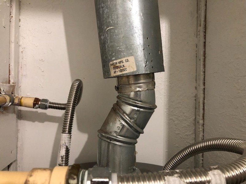 Responded to manufactured home for propane water heater replacement estimate. Upon inspection, confirmed existing water heater installation does not meet manufactured home specifications. Evaluated current venting system including Queen Manufacturing NS-1800CC roof jack assembly and determined replacement required to meet code compliance. Assessed existing copper plumbing configuration, shutoff valves, and flexible connectors at water heater base. Documented equipment specifications and venting requirements. Provided estimate for proper manufactured home-rated propane water heater installation including compliant venting components and necessary roof jack replacement.