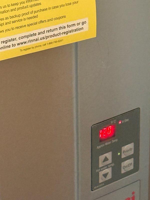 Performed maintenance service on Rinnai tankless water heater unit per estimate specifications. Inspected control panel functionality and verified proper temperature display reading at 120-125°F. Applied company service label to unit for maintenance tracking purposes and ensured product registration documentation remained visible for customer reference.