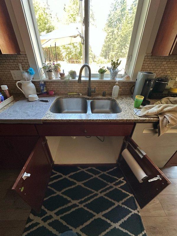 Responded to complaint of garbage disposal backing up and draining slowly. Upon arrival, accessed property using provided gate code and inspected kitchen sink area. Homeowner had already attempted basic troubleshooting including restarting unit, unplugging, and cleaning accessible portions of disposal.

Opened cabinet doors beneath double-basin stainless steel sink to examine Wolverine brand garbage disposal unit and associated plumbing. Conducted thorough inspection of disposal unit, drain connections, and P-trap configuration. Evaluated PVC drainage system for potential blockages, improper venting, or compromised pipe integrity that could cause slow drainage issues.

Tested disposal operation and observed drainage performance. Checked electrical connections to ensure proper power supply to unit. Examined mounting assembly and discharge elbow connection to drainage system. Assessed P-trap and downstream piping for debris accumulation or partial obstruction. Documented existing install