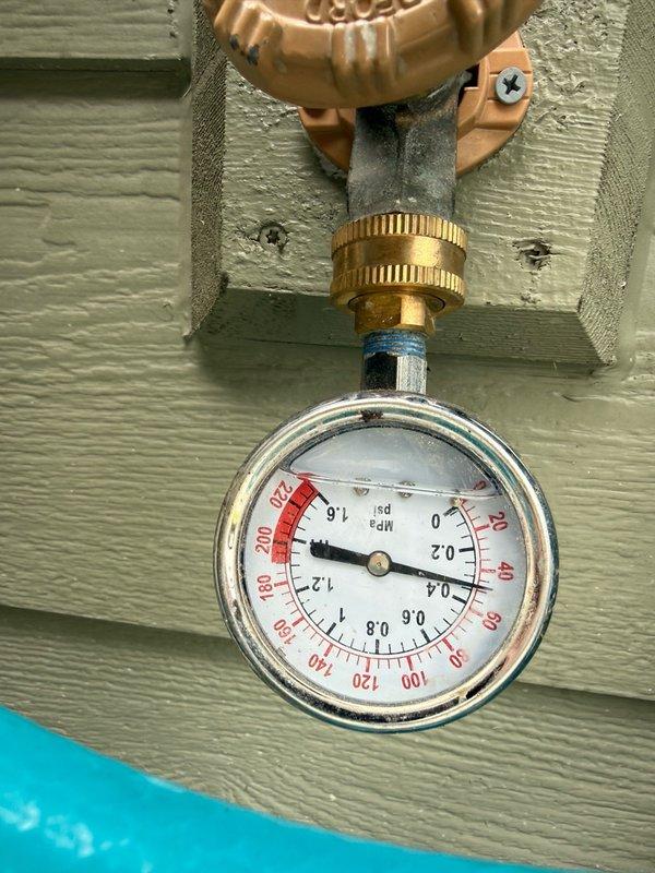 Responded to service call for irrigation valve system evaluation in garage area. Performed comprehensive diagnostic assessment of irrigation system components including pressure testing at outdoor spigot and inspection of pressure reducing valve assembly. Testing revealed zero PSI reading at hose bib connection point, indicating potential system pressurization issue or valve malfunction. Documented condition of brass pressure reducing valve (model 850) installed on PVC piping with visible weathering and outdoor exposure. Noted grounding wires properly attached to valve assembly. Captured photographic documentation of all system components for reference. Provided complimentary estimate and presented multiple repair options to address identified pressure regulation concerns and restore proper irrigation system functionality.