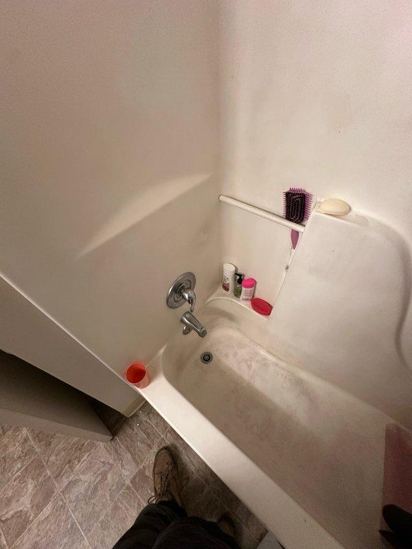 Completed diagnostic inspection of bathroom plumbing fixtures. Examined bathtub faucet assembly, tub spout, and shower valve control for operational issues, leaks, and mineral buildup. Documented condition of chrome fixtures showing wear and discoloration around mounting points, indicating potential seal deterioration requiring future attention.