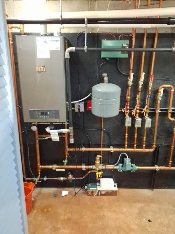Responded to no hot water and no heat call. Upon arrival, inspected wall-mounted boiler system and domestic hot water heater serving the residence. Evaluated extensive copper piping manifold configuration, expansion tank, circulator pump, and zone valves throughout the heating distribution system. Diagnosed system failure affecting both space heating and domestic hot water production. Performed necessary repairs to restore boiler operation and verified proper function of all heating zones. Tested domestic hot water heater connections and confirmed adequate hot water delivery. Cycled system through complete heating cycle, verified circulator pump operation, checked expansion tank pressure, and confirmed all zone valves responding appropriately. System restored to full operational status with both heat and hot water functioning normally throughout the residence.