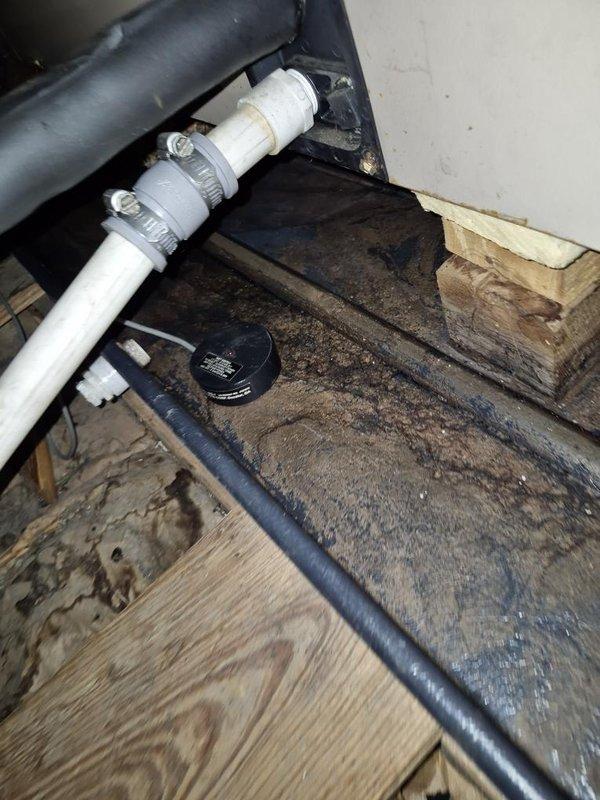 Completed seasonal maintenance on single-zone air conditioning system. Accessed air handler unit in attic space, inspected and documented condition of pleated air filter showing moderate dust accumulation, verified proper installation and secure mounting of unit. Inspected crawl space plumbing infrastructure including PVC drainage lines with metal band clamps and associated connections, confirmed structural integrity of floor joists and underfloor components.