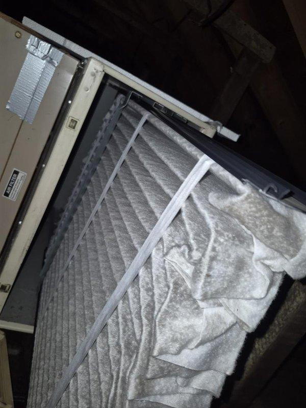 Completed seasonal maintenance on single-zone air conditioning system. Accessed air handler unit in attic space, inspected and documented condition of pleated air filter showing moderate dust accumulation, verified proper installation and secure mounting of unit. Inspected crawl space plumbing infrastructure including PVC drainage lines with metal band clamps and associated connections, confirmed structural integrity of floor joists and underfloor components.