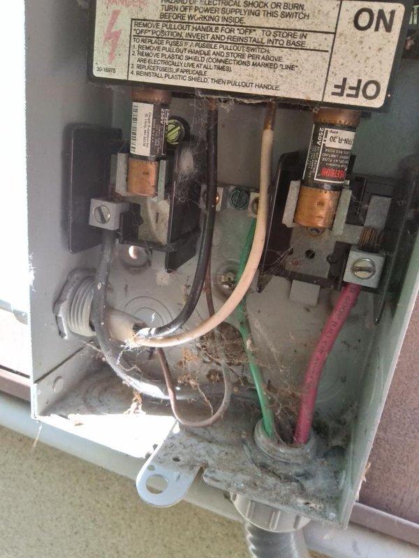 Performed comprehensive assessment of existing air conditioning system per customer request for replacement unit. Documented current equipment condition including outdoor condenser unit and electrical disconnect components. Inspection revealed aging system with visible wear on electrical disconnect box showing corrosion, debris accumulation, and weathered fuse assembly. Photographed equipment specifications and existing installation for replacement estimate preparation. Provided customer with equipment upgrade options and system replacement recommendations based on current unit age and condition.