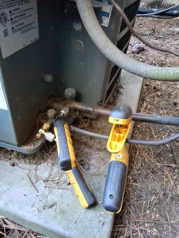 Responded to no cooling call and performed diagnostic evaluation of residential air conditioning system. Connected manifold gauges to service ports and assessed refrigerant pressures on outdoor condensing unit. Unit showed signs of operational issues requiring pressure testing to determine system status. Documented equipment condition and gauge readings with photographs for service records.
