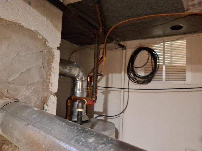 Responded to gas leak repair call with scheduled arrival window. Upon inspection, identified compromised gas piping system requiring immediate attention. Performed necessary access work through ceiling and wall areas to expose affected gas lines. Executed complete gas repipe installation, removing deteriorated sections and installing new black iron gas piping with proper fittings and connections. Installed new shut-off valve for system isolation and safety compliance. Routed new gas line through structural joists following code requirements for proper support and clearance. Pressure tested entire gas system to verify integrity and confirm zero leakage at all connections and joints. Restored gas service to affected appliances and verified proper operation. Tagged new installation for inspection compliance. Work completed successfully with all safety protocols observed.