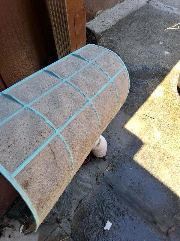 Responded to service call for mini split system with insufficient airflow, a recurring issue. Upon inspection, found outdoor unit showing significant age and weathering with accumulated debris around base and exterior surfaces. Removed and inspected indoor air filter, which exhibited heavy dust and debris accumulation causing restricted airflow. Cleaned filter and reinstalled unit. Discussed system performance concerns with customer and provided estimate for complete mini split replacement due to recurring operational issues and overall system condition.