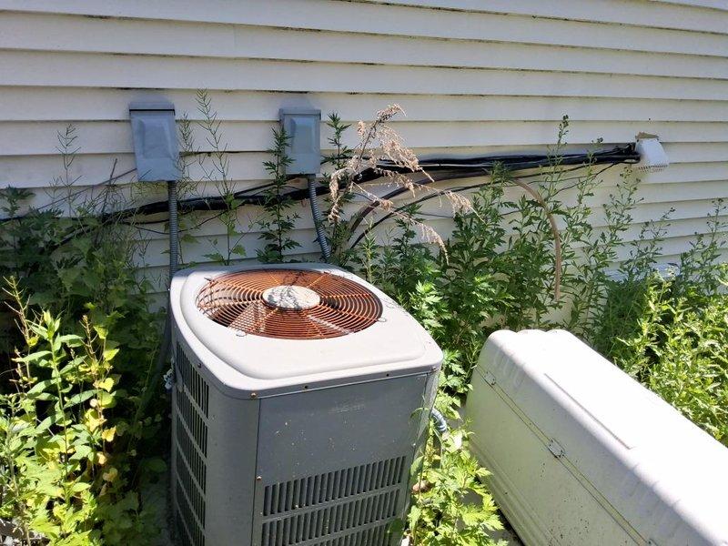Completed full HVAC system replacement including new furnace, evaporator coil, and outdoor condensing unit. Installed two matching condenser units on exterior pad against building with proper clearances and refrigerant line connections. Routed copper refrigerant lines and electrical conduit along exterior wall to new equipment locations. All units commissioned and tested for proper operation with refrigerant charge verified to manufacturer specifications.