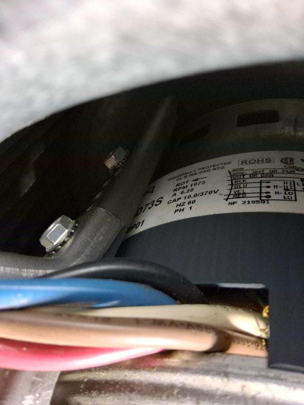 Responded to no cooling complaint with reported loud noise. Upon inspection, found failed compressor motor with seized bearings causing operational failure and excessive noise. Documented existing wiring configuration and control board connections. Diagnosed compressor as non-functional and requiring replacement. Verified 370V run capacitor specifications and existing electrical connections to circuit board. Photographed motor specifications, wiring harness, and control board assembly for replacement reference. Unit remains non-operational pending compressor replacement.