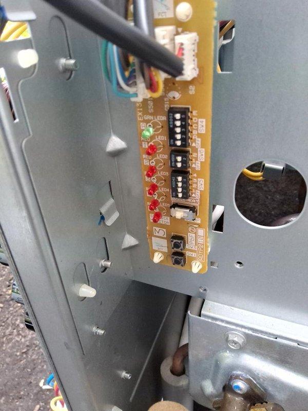 Responded to no cooling call with error codes displaying on unit. Removed top panel and accessed control board to diagnose issue. Inspected circuit board and found fault indicators illuminated on LED display. Removed wireless adapter and associated wiring to test board functionality. Checked all wire connections at control board terminals and verified proper seating of connectors. Cleared error codes, reassembled unit with all panel screws, and restored system to normal operation.