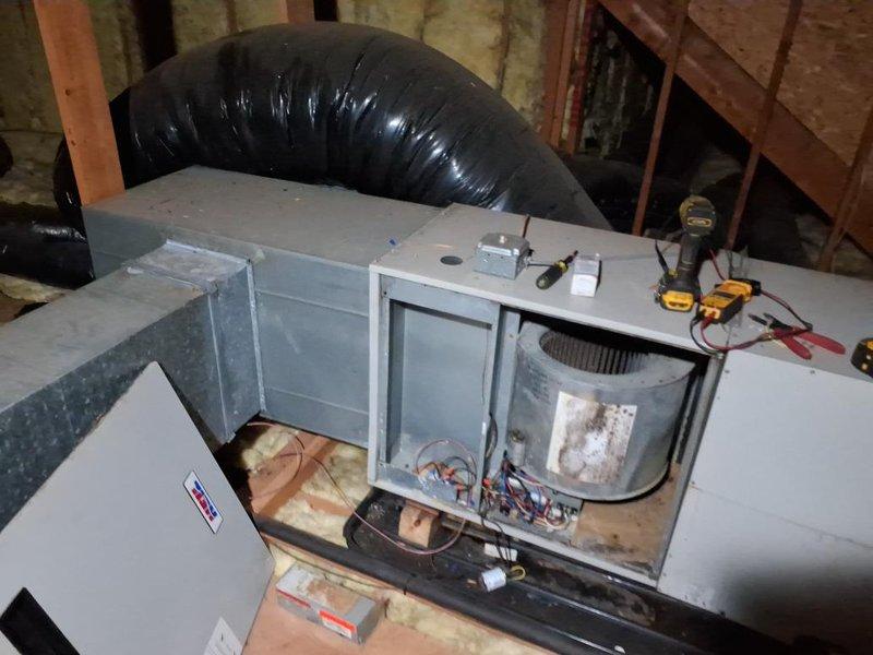 Responded to no cooling call with reported leak. Upon inspection in attic, found air handler with accessible internal components including blower motor assembly and filter. Performed diagnostic testing using multimeter to assess electrical connections and system functionality. Inspected refrigerant lines, ductwork connections, and condensate drainage system. Located source of leak and completed necessary repairs to restore proper operation. Verified system cooling capacity and confirmed all components functioning within normal parameters before departure.